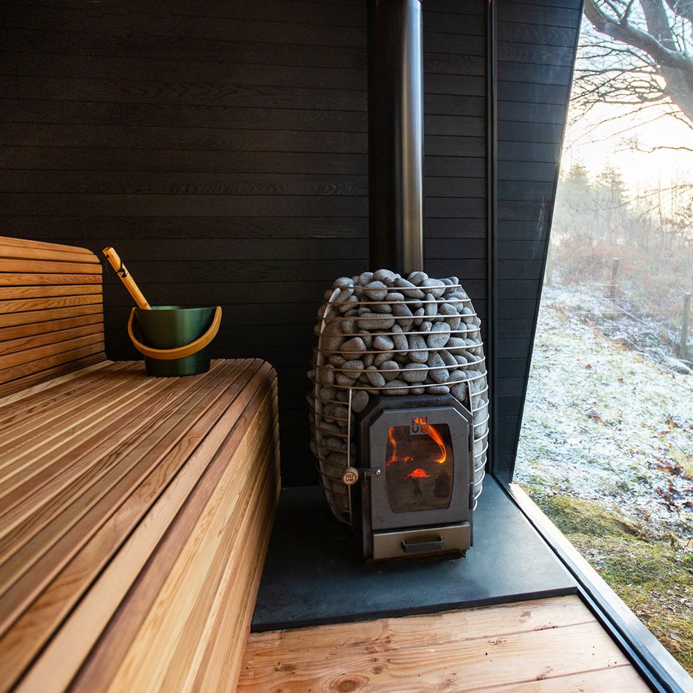 Traditional Wood-Burning Sauna Heater with Glowing Firewood